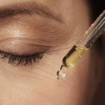 Female eye and dropper with rejuvenating serum